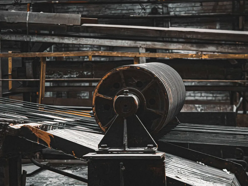 Grooved steel drum on a pedestal bearing guiding strands of wire in a wire mill